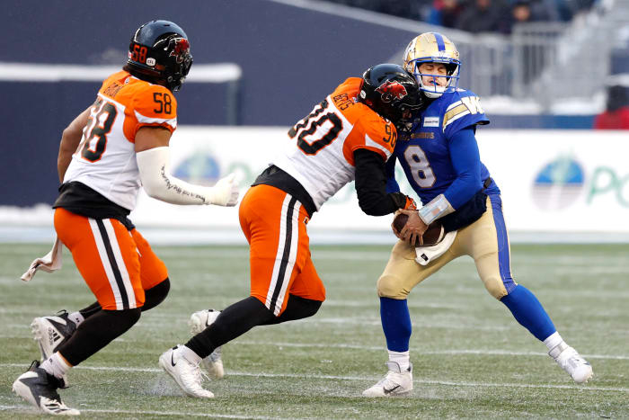 Nov 13, 2022; Winnigeg, Manitoba, CAN; BC Lions defensive lineman Mathieu Betts (90) tackles Winnipeg Blue Bombers quarterback Zach Collaros (8) in the first half at Investors Group Field. Mandatory Credit: James Carey Lauder-USA TODAY Sports